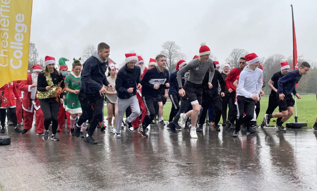 Students and staff on the starting line of the Santa Dash in Queens Park