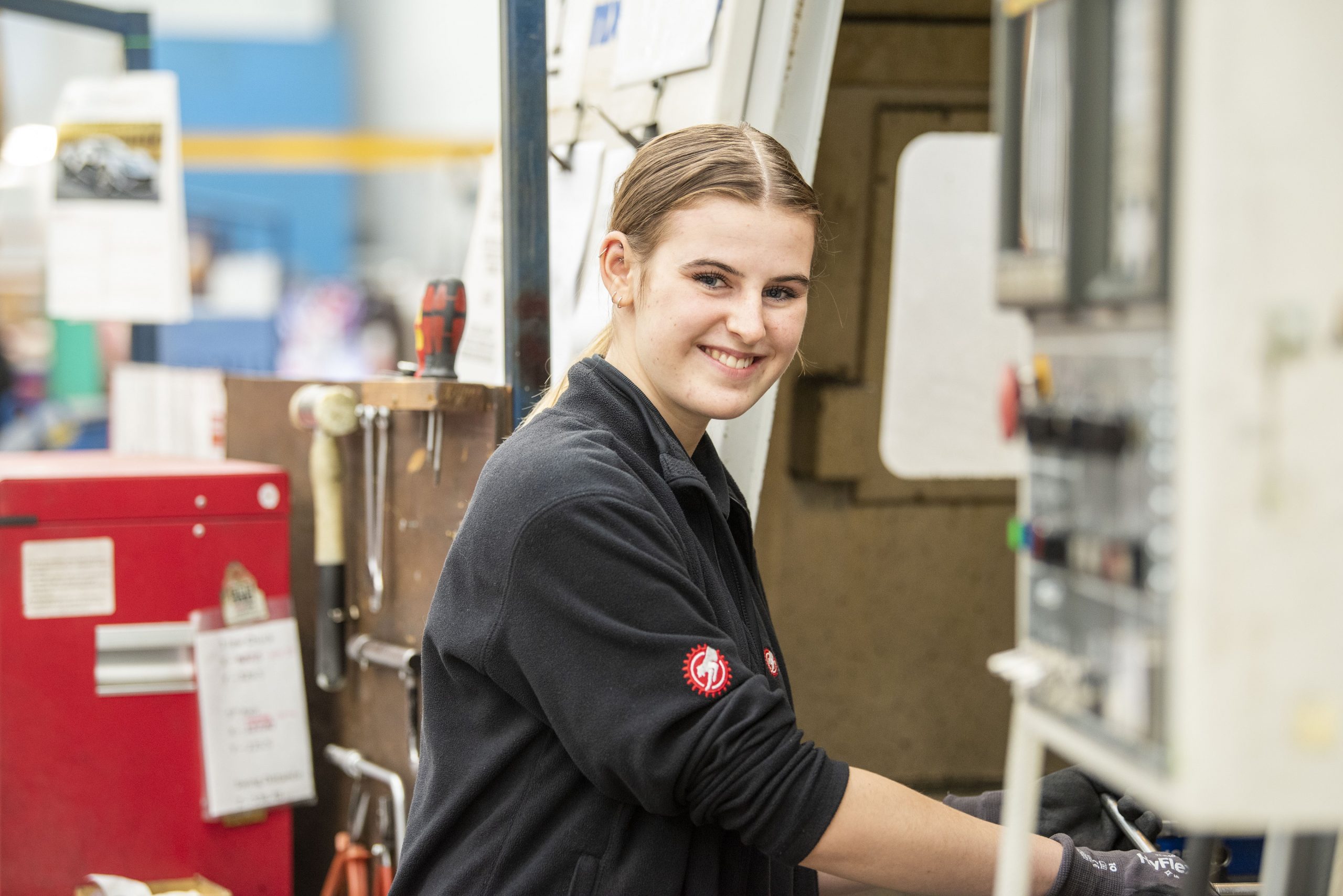 An engineering apprentice smiling